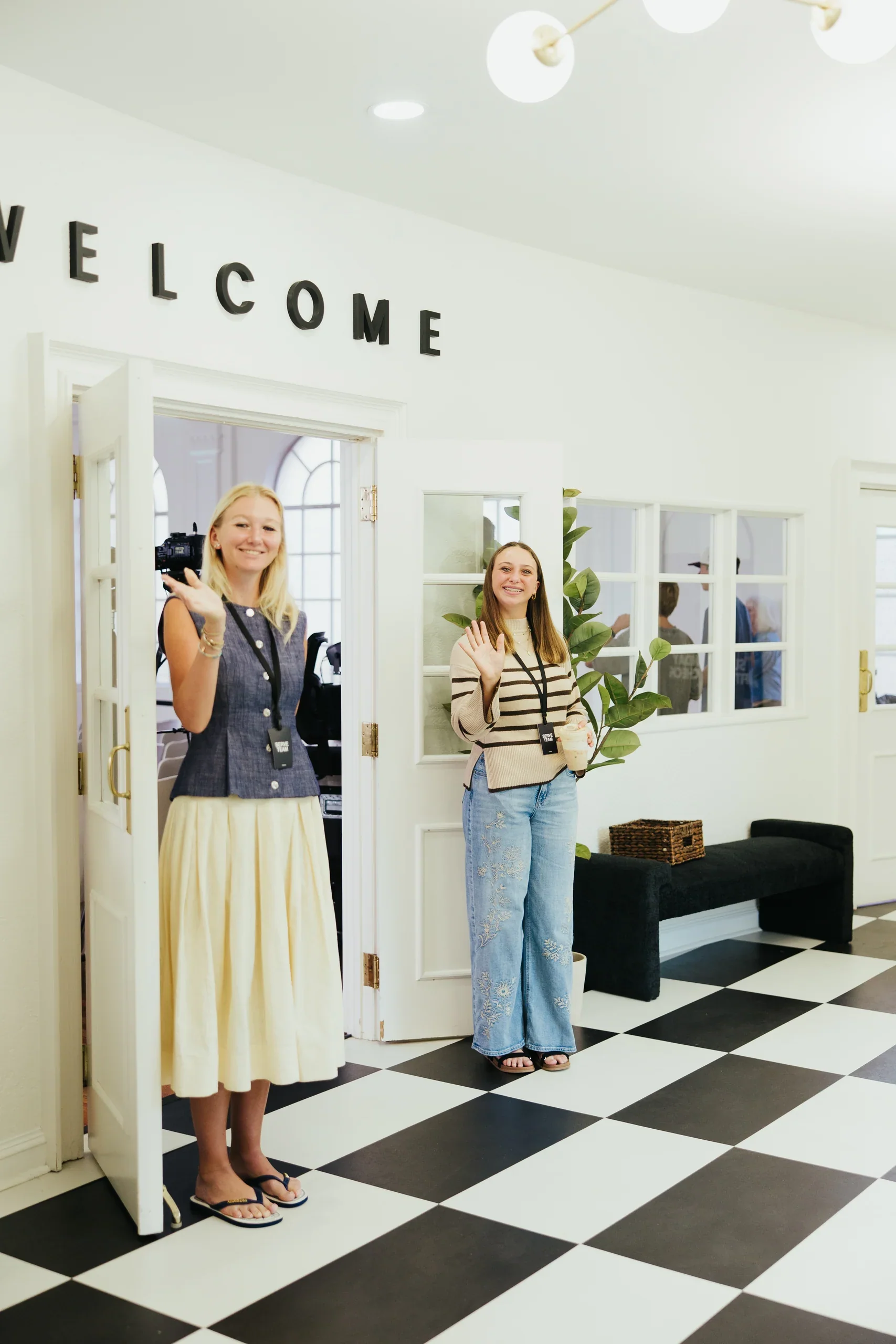 Two Harbour Church serve team members welcoming guests at the entrance