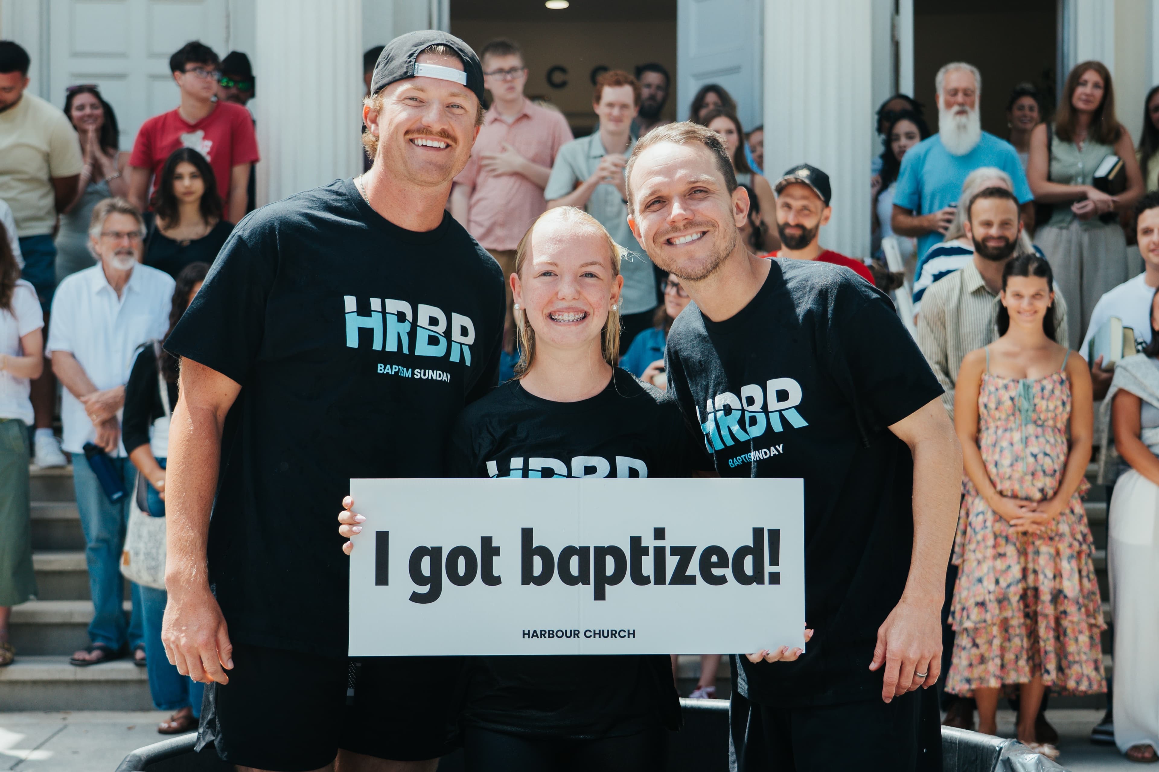 A newly baptised believer with the I got baptized sign