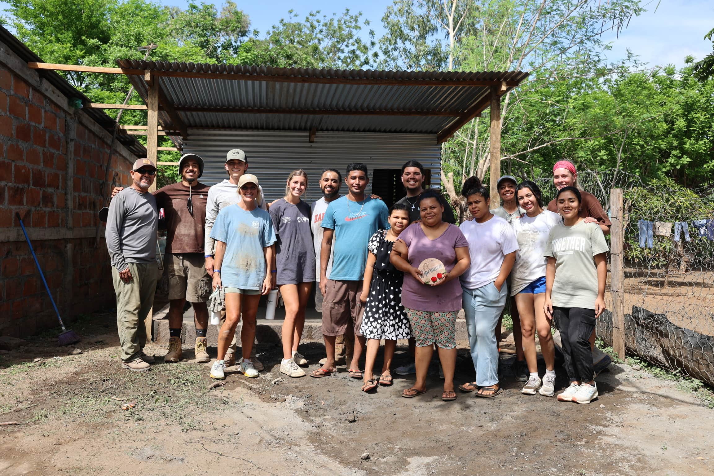 A Harbour team celebrating with a family outside their finished home
