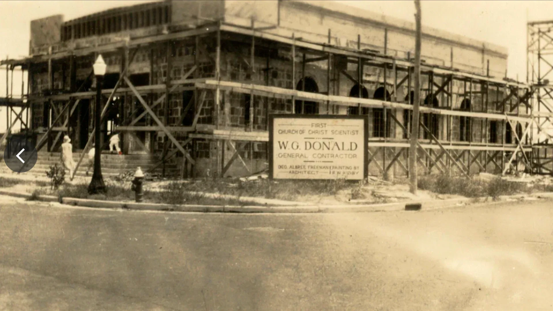 Historic photograph of the church building under construction, with scaffolding across the front and side.